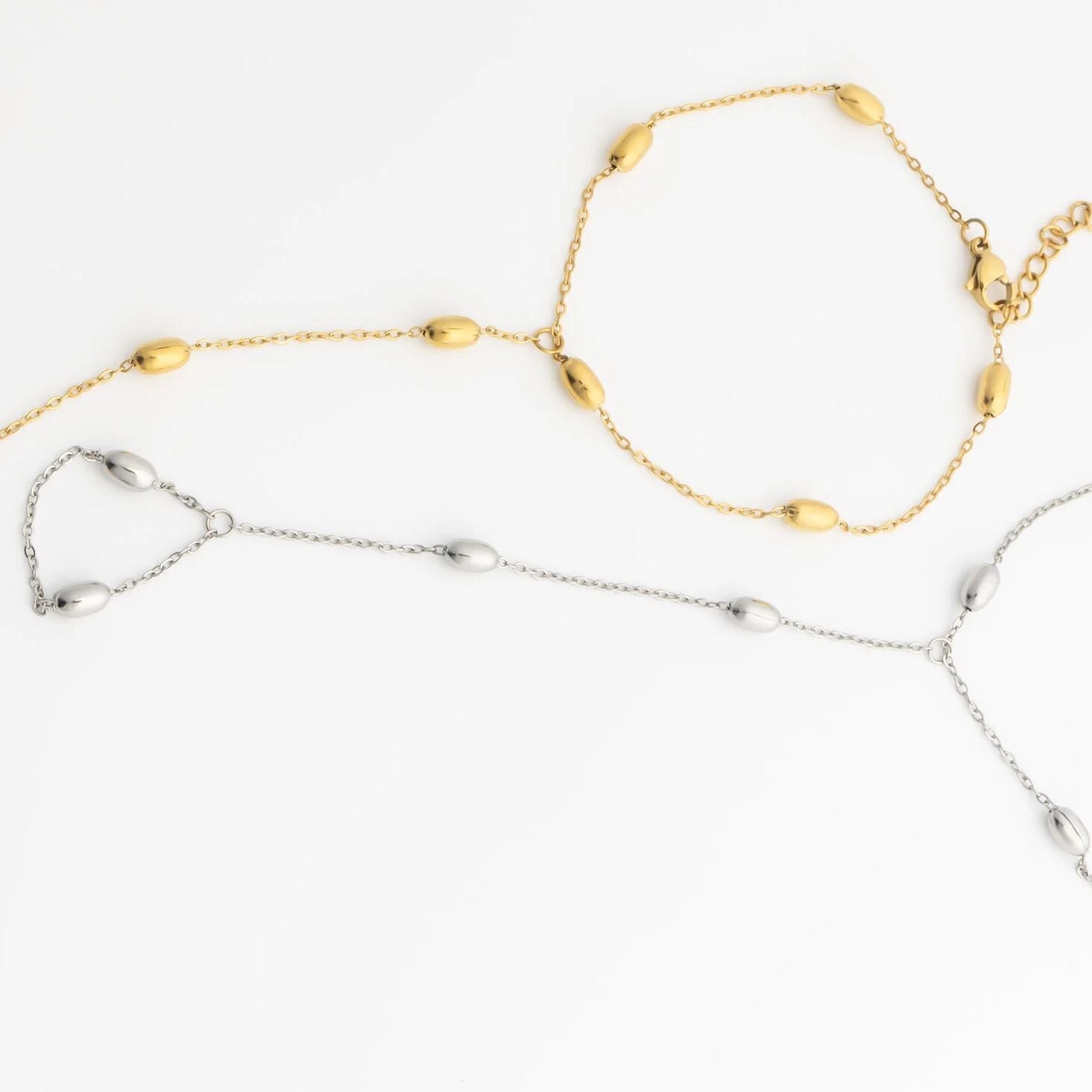 Gold and silver Statement Bead Hand Chains on a white background