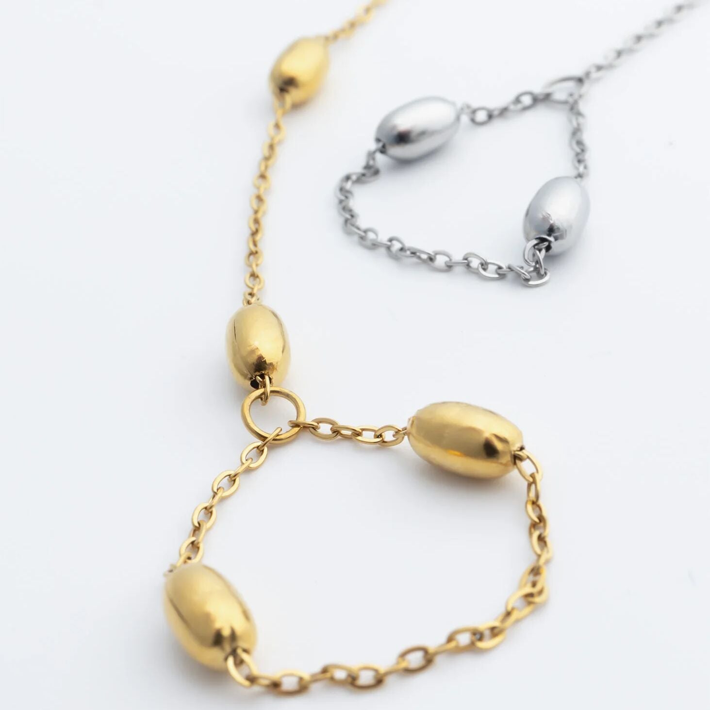 Gold and silver Statement Bead Hand Chains on a white background