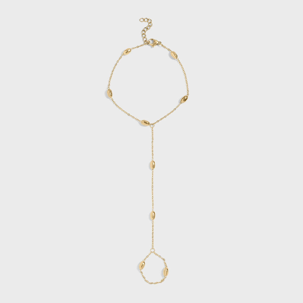 Gold hand chain on a light gray background