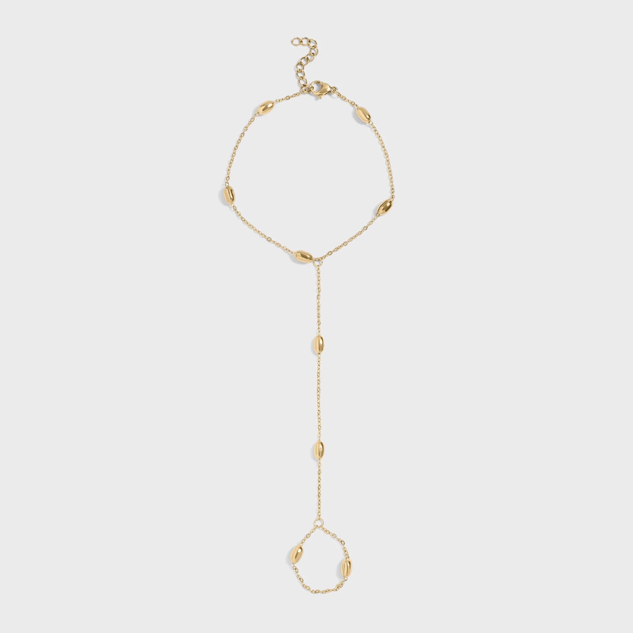 Gold hand chain on a light gray background