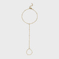 Gold hand chain on a light gray background