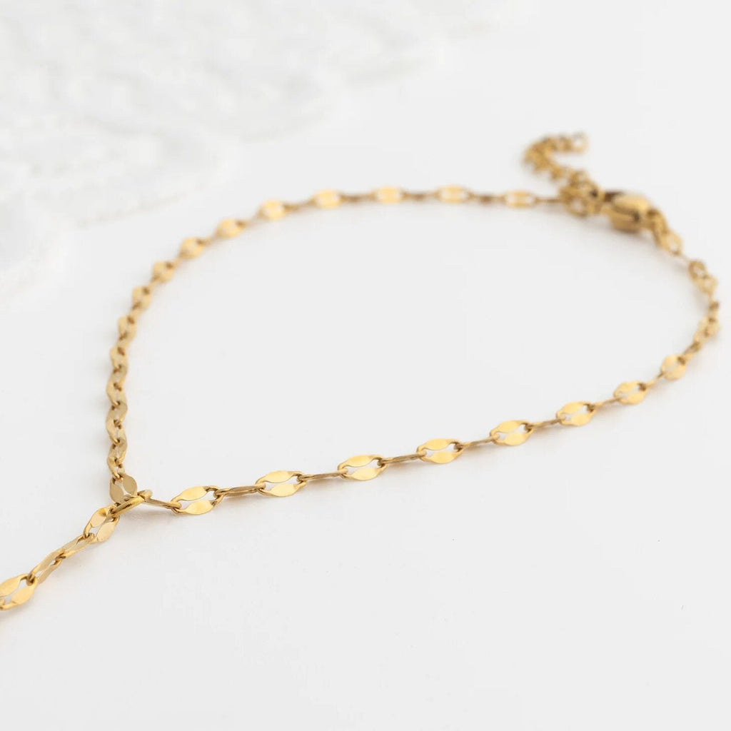 Gold Lip Hand Chain on a light gray background