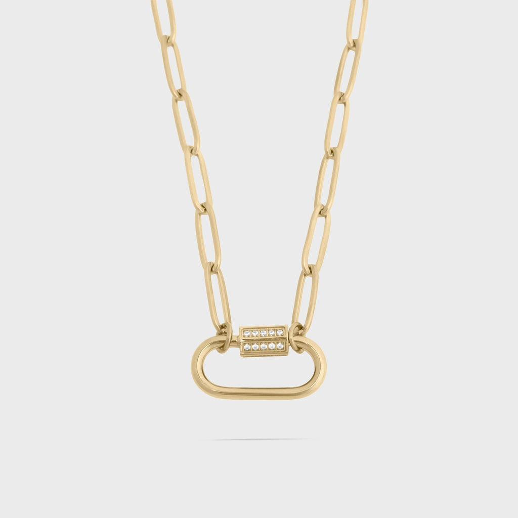 Gold chain necklace with a unique clasp on a light gray background