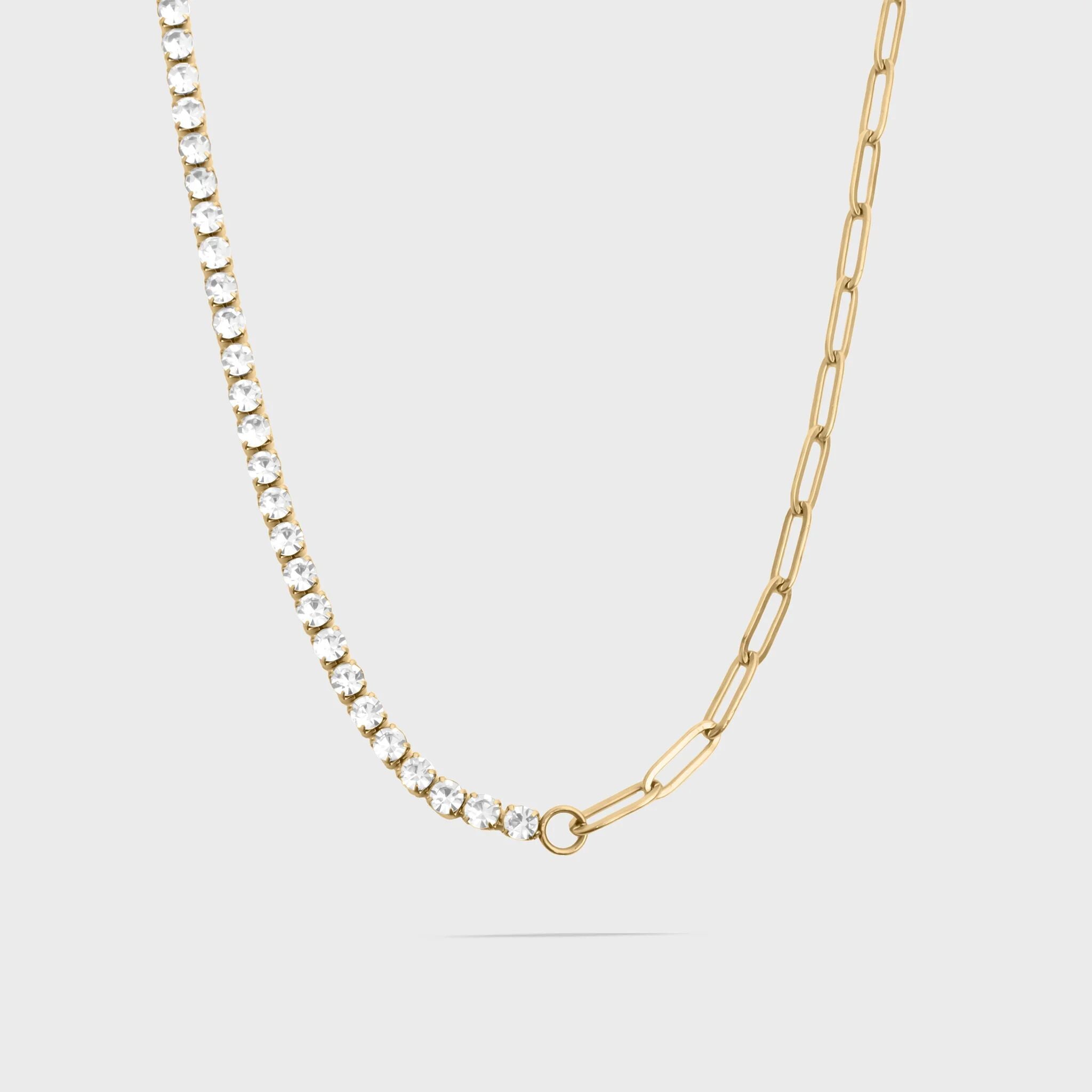 Gold chain necklace with small diamonds on a light gray background