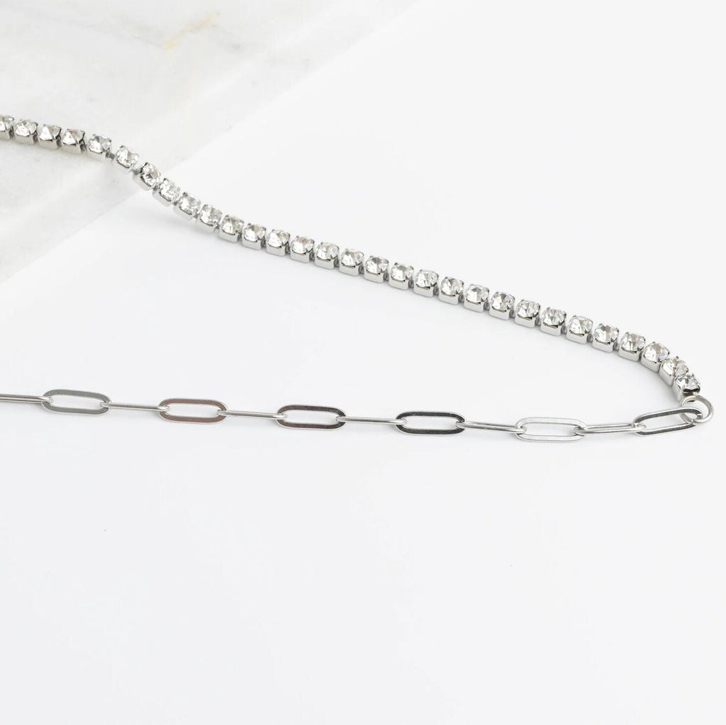 Silver chain necklace with small diamonds on a white background