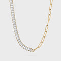 Gold necklace with clear gemstones on a light gray background