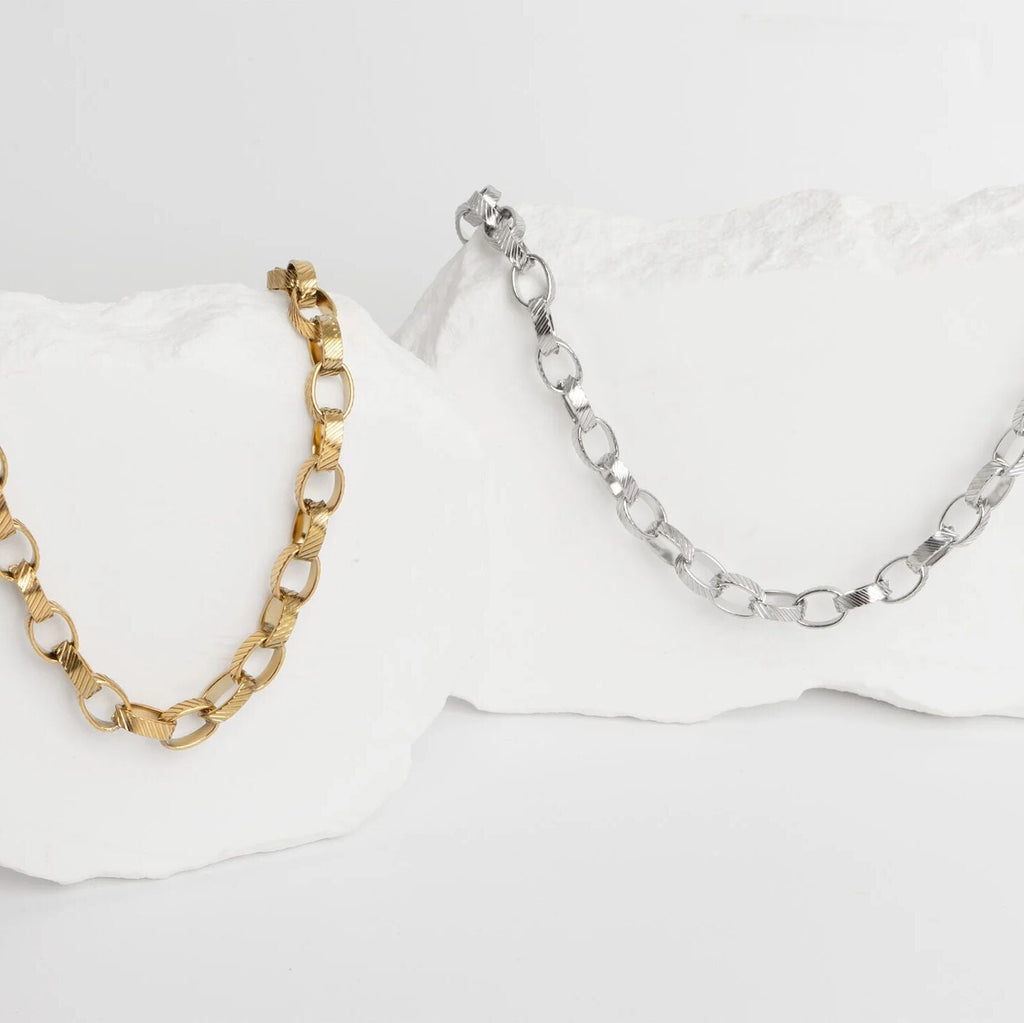 Gold and silver chain necklaces on a white background