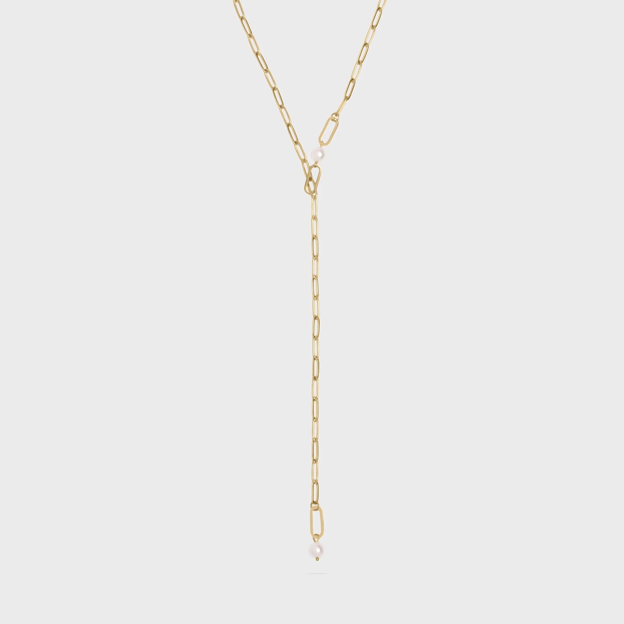 Gold y-shaped chain necklace on a light gray background