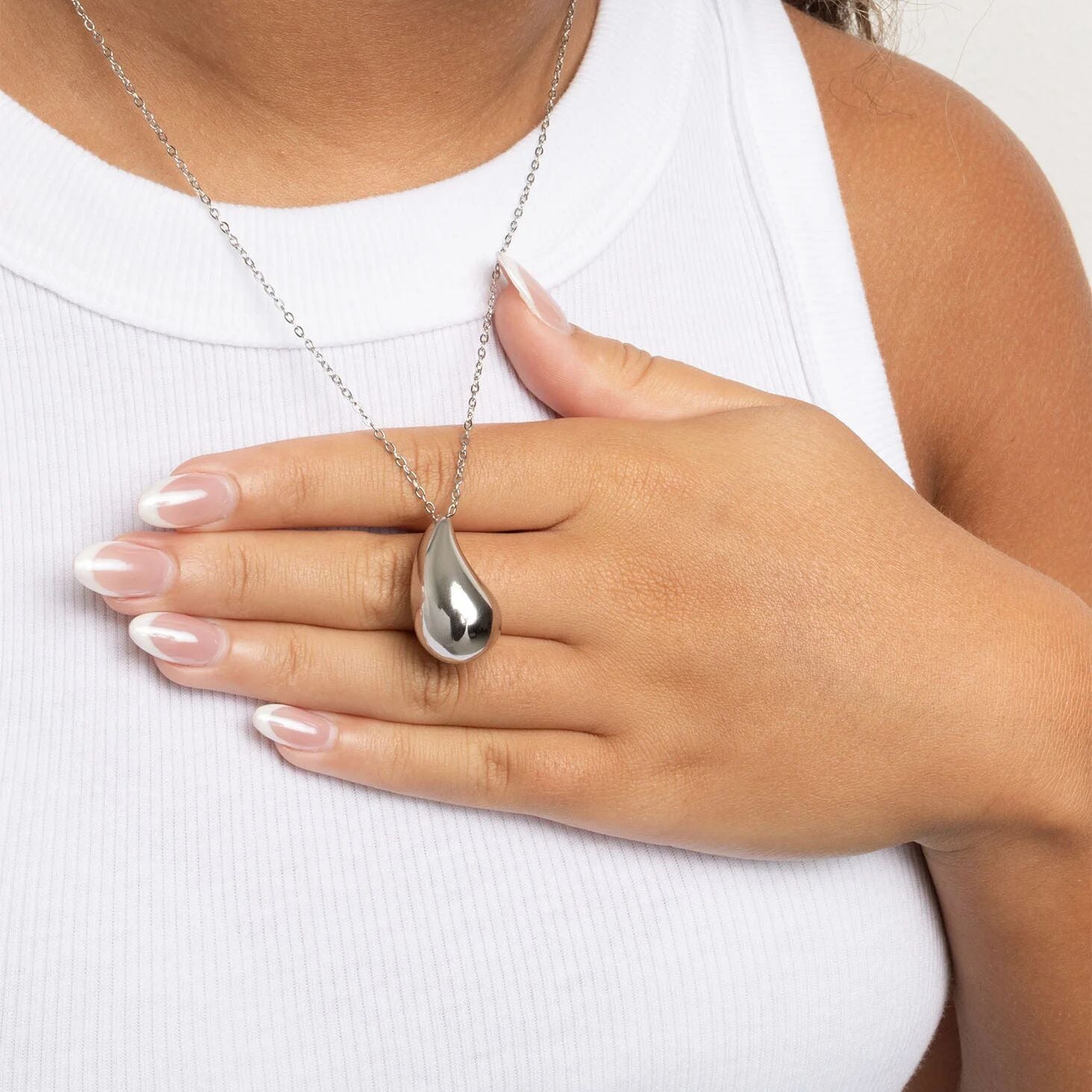 Silver teardrop pendant necklace on a white background