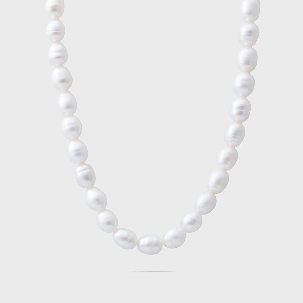 Pearl necklace on a light gray background