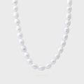 Pearl necklace on a light gray background