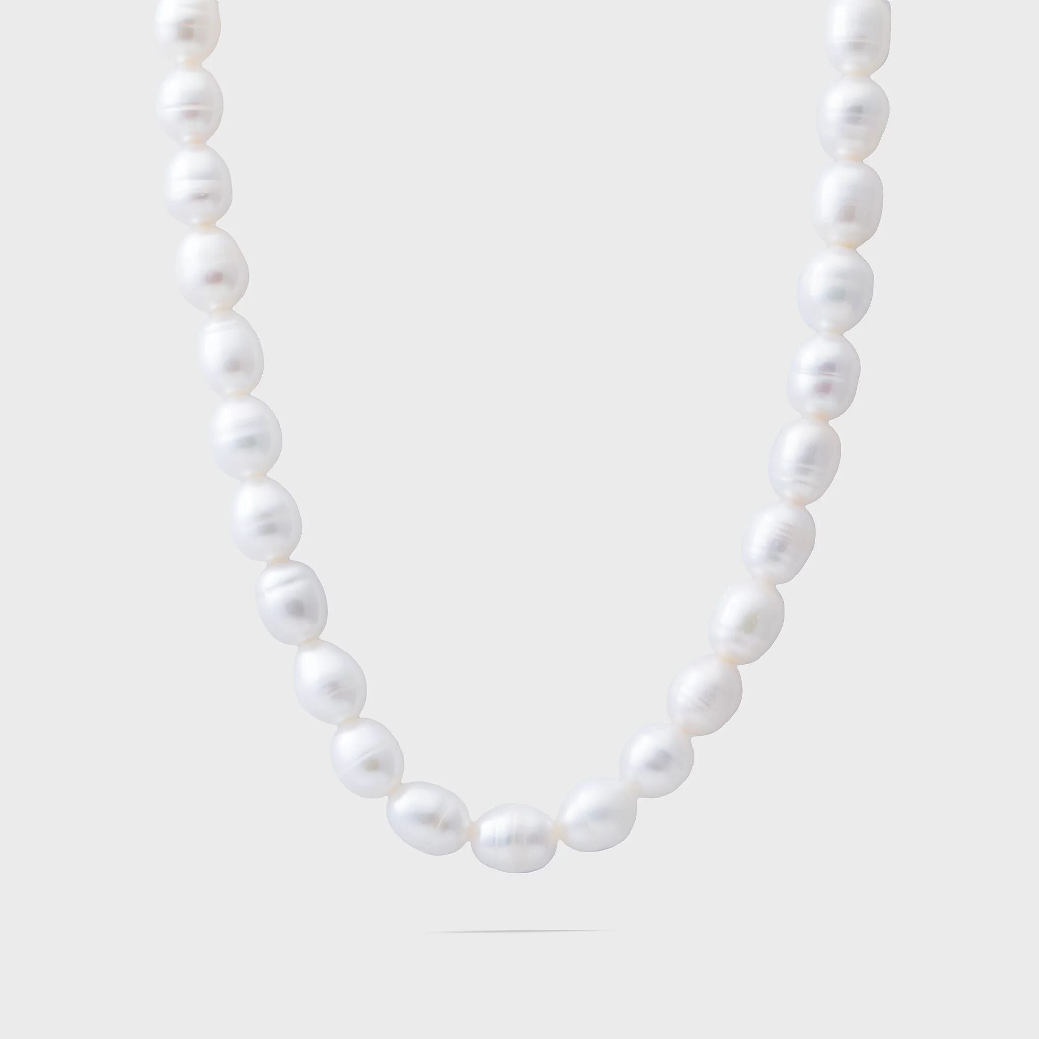 Pearl necklace on a light gray background