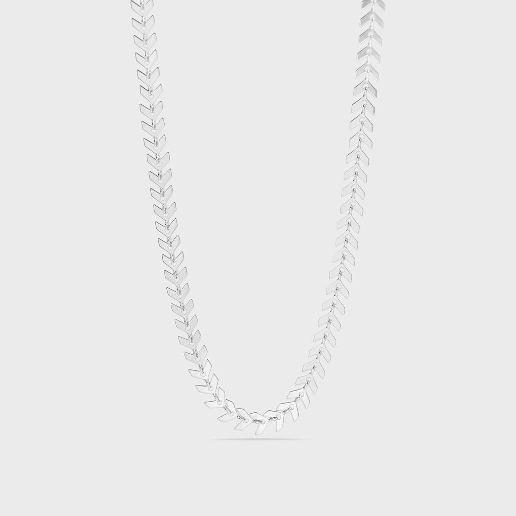 Silver necklace with leaf-like pendants on a light gray background