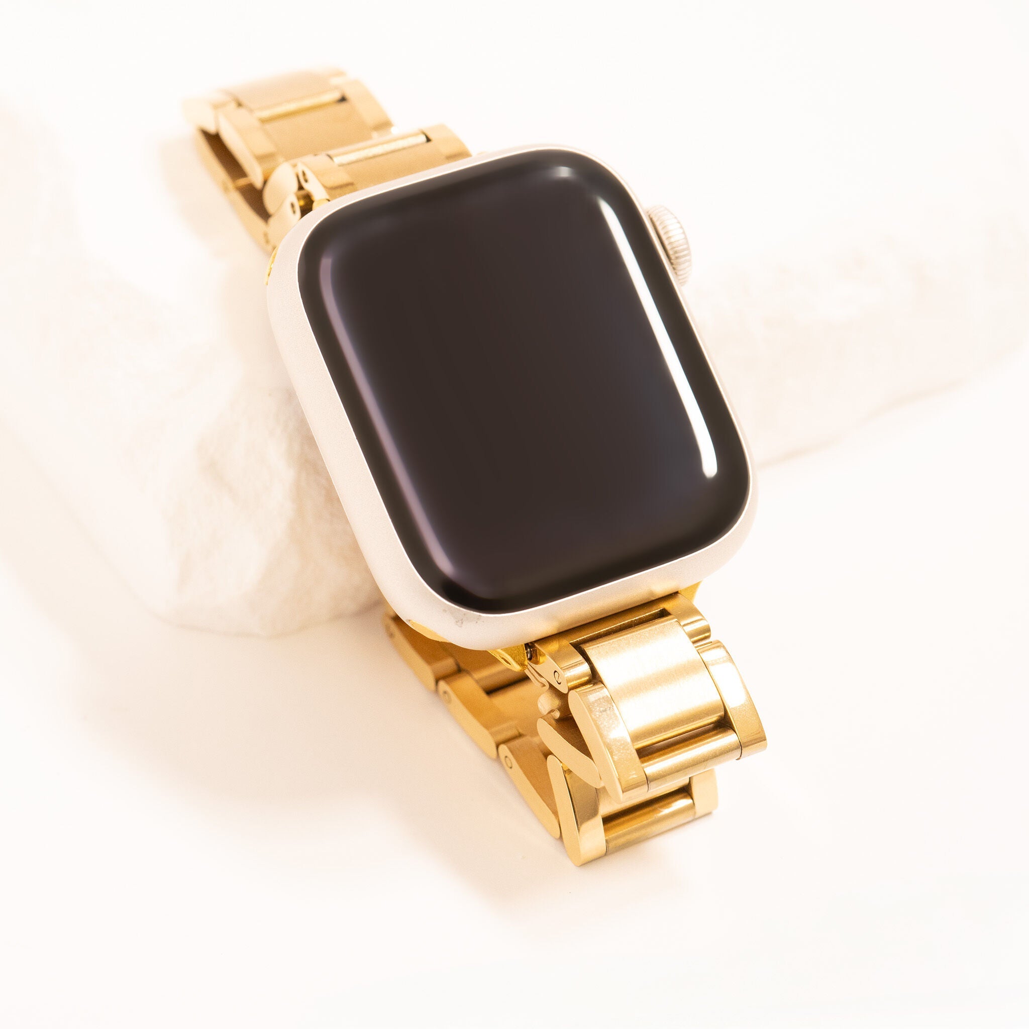 Gold smartwatch with a black screen on a white background
