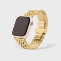 Gold watch with a metallic band on a light gray background