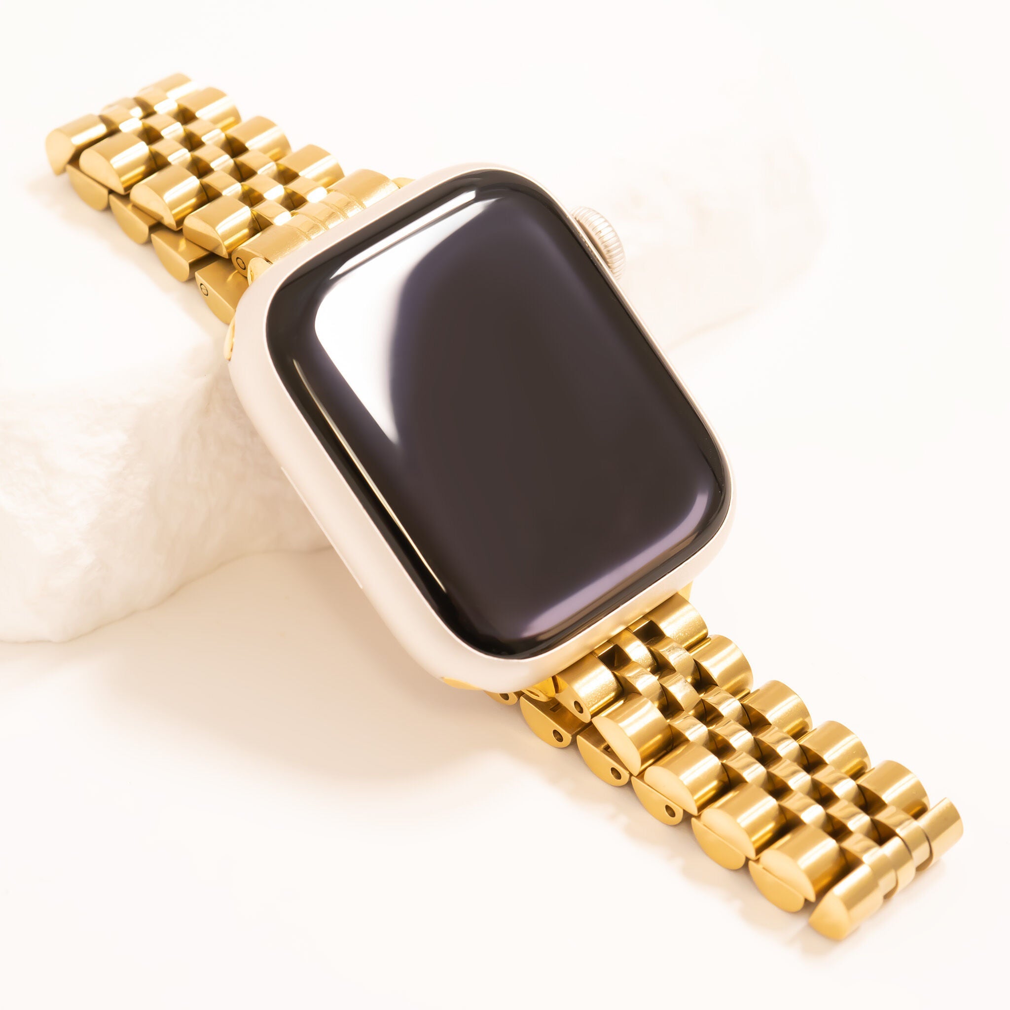 Gold watch band on a white background