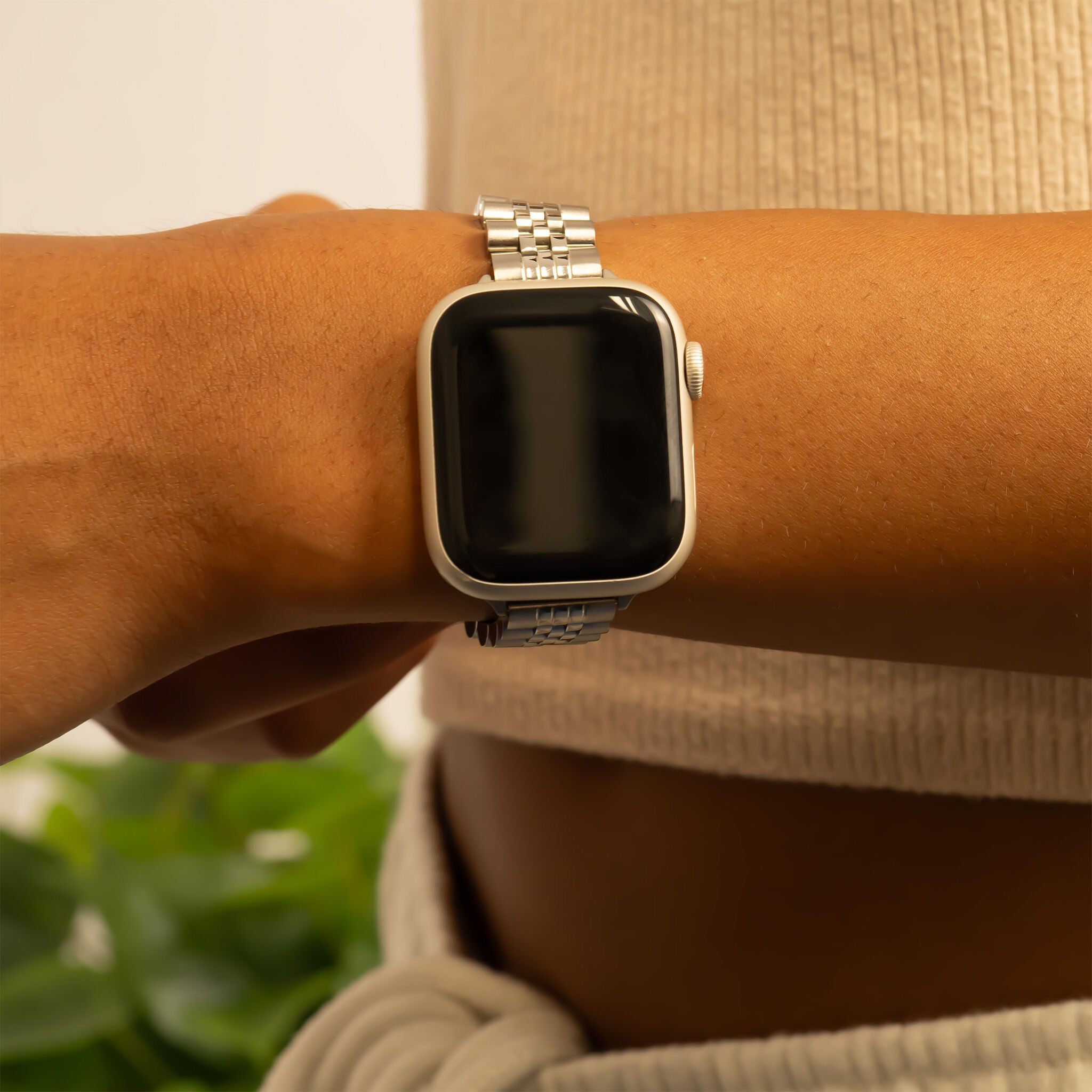 Person wearing a smartwatch on a blurred background