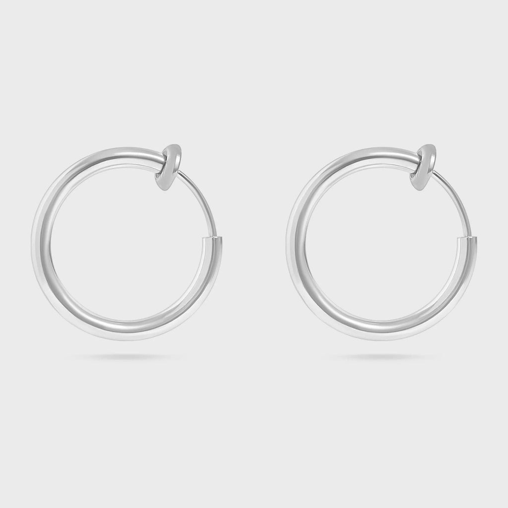 Pair of silver hoop earrings on a light gray background