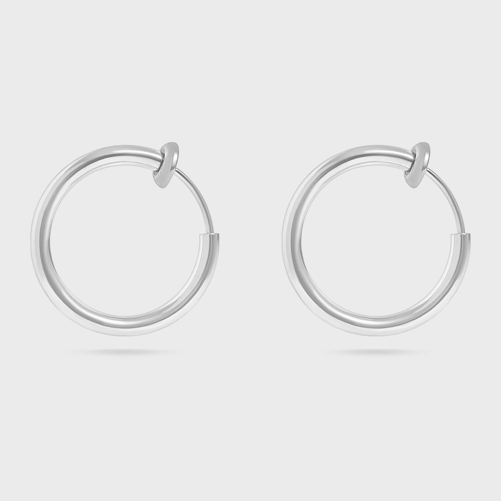 Pair of silver hoop earrings on a light gray background
