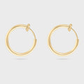 Gold hoop earrings on a light gray background