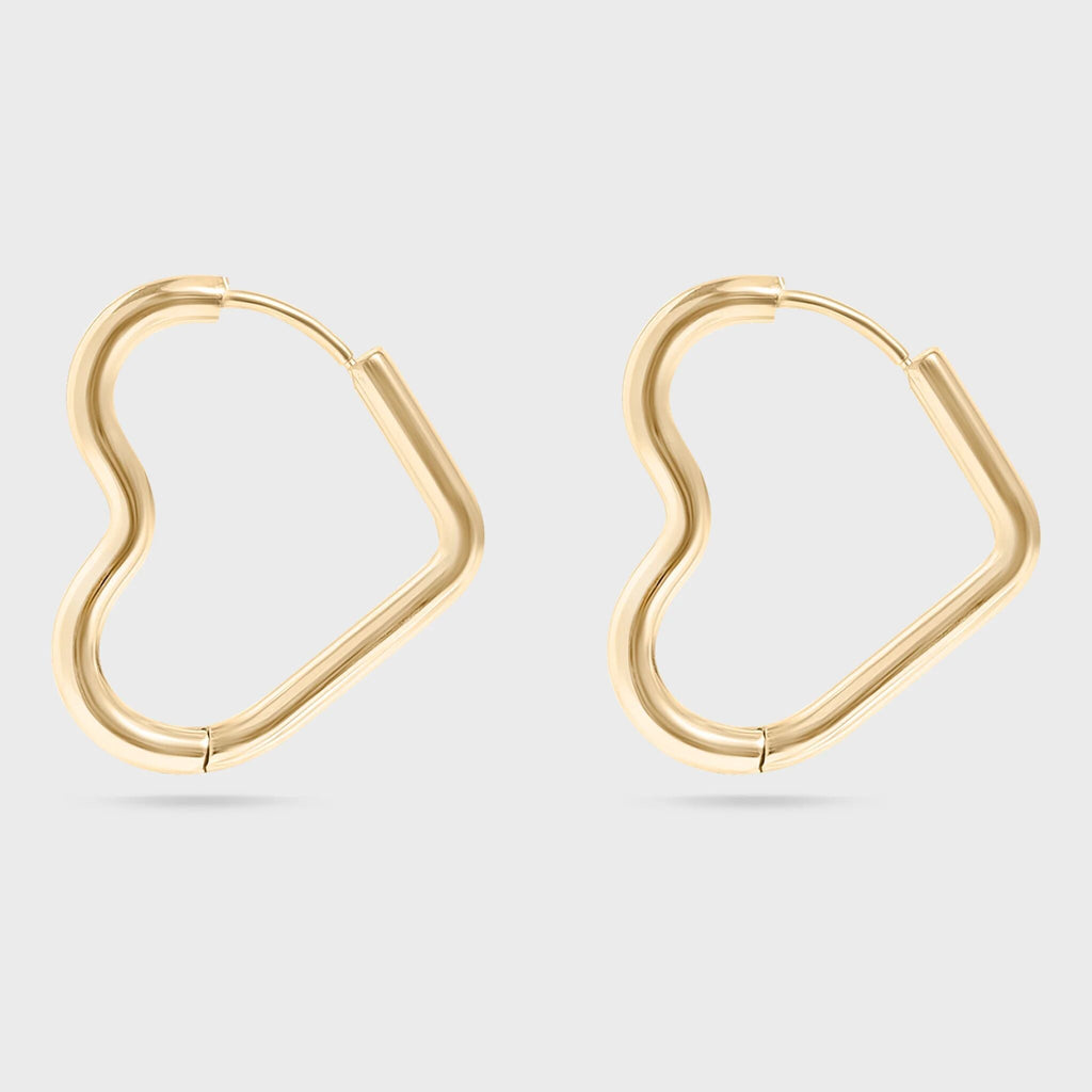 Heart Shaped gold hoop earrings on a light gray background