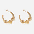 A pair of gold-colored hoop earrings with a twisted abstract circle design, displayed against a white background