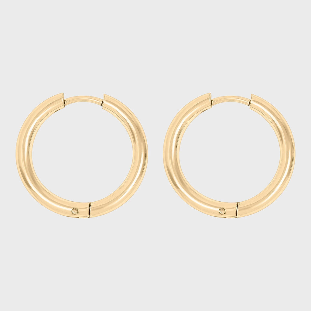 Gold hoop earrings on a light gray background