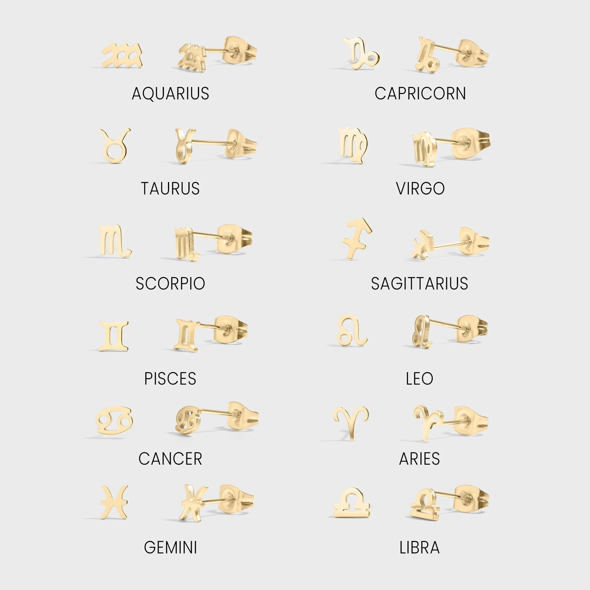 Set of gold earrings corresponding to each zodiac sign on a light gray background