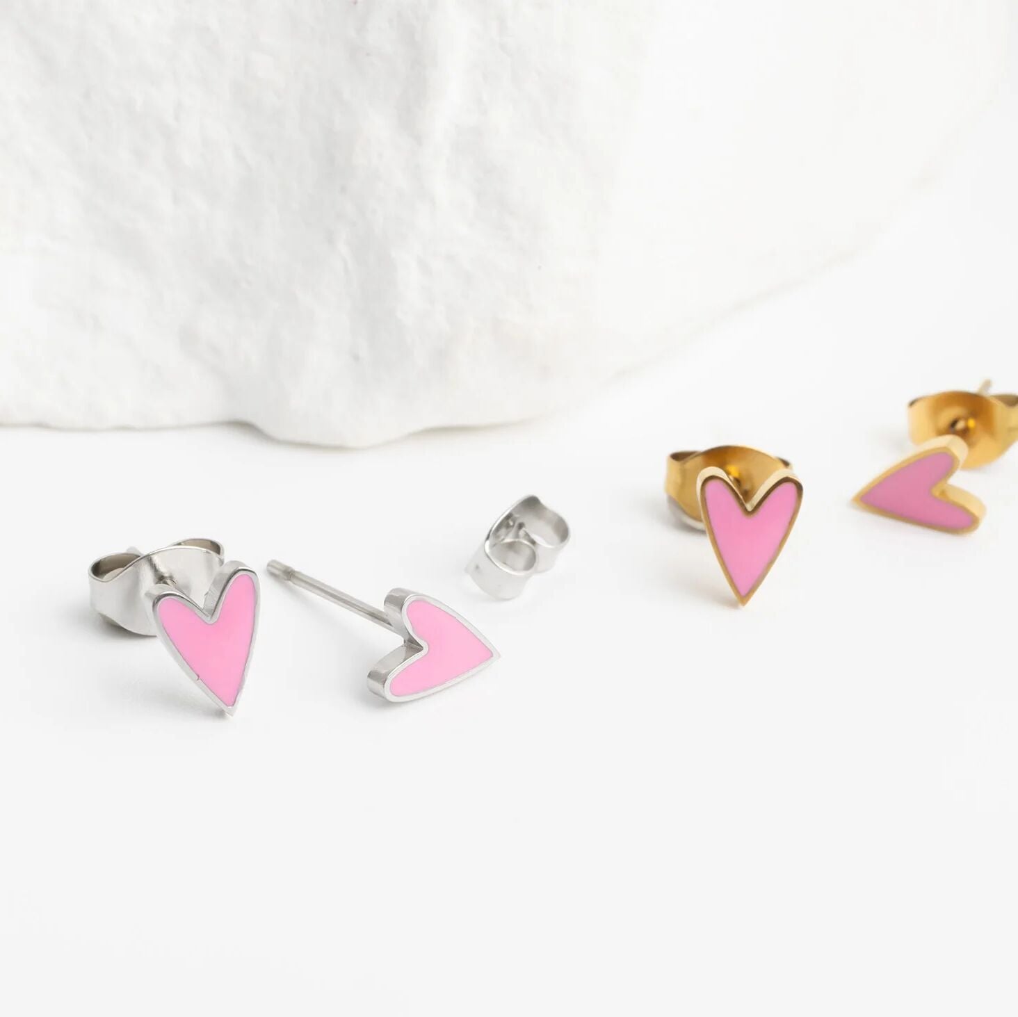 Heart-shaped earrings on a white background