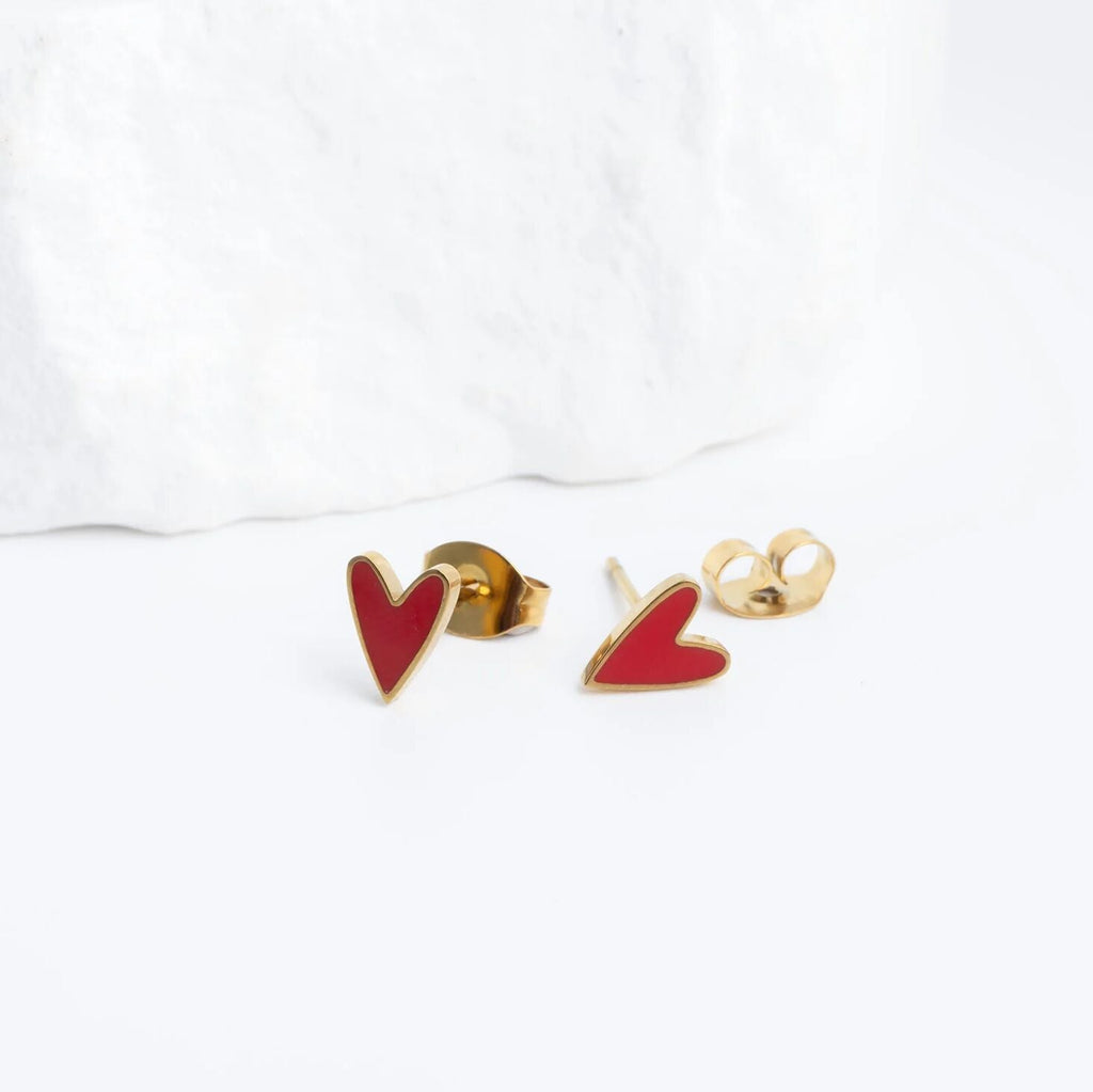 Red heart-shaped earrings with gold posts on a white background