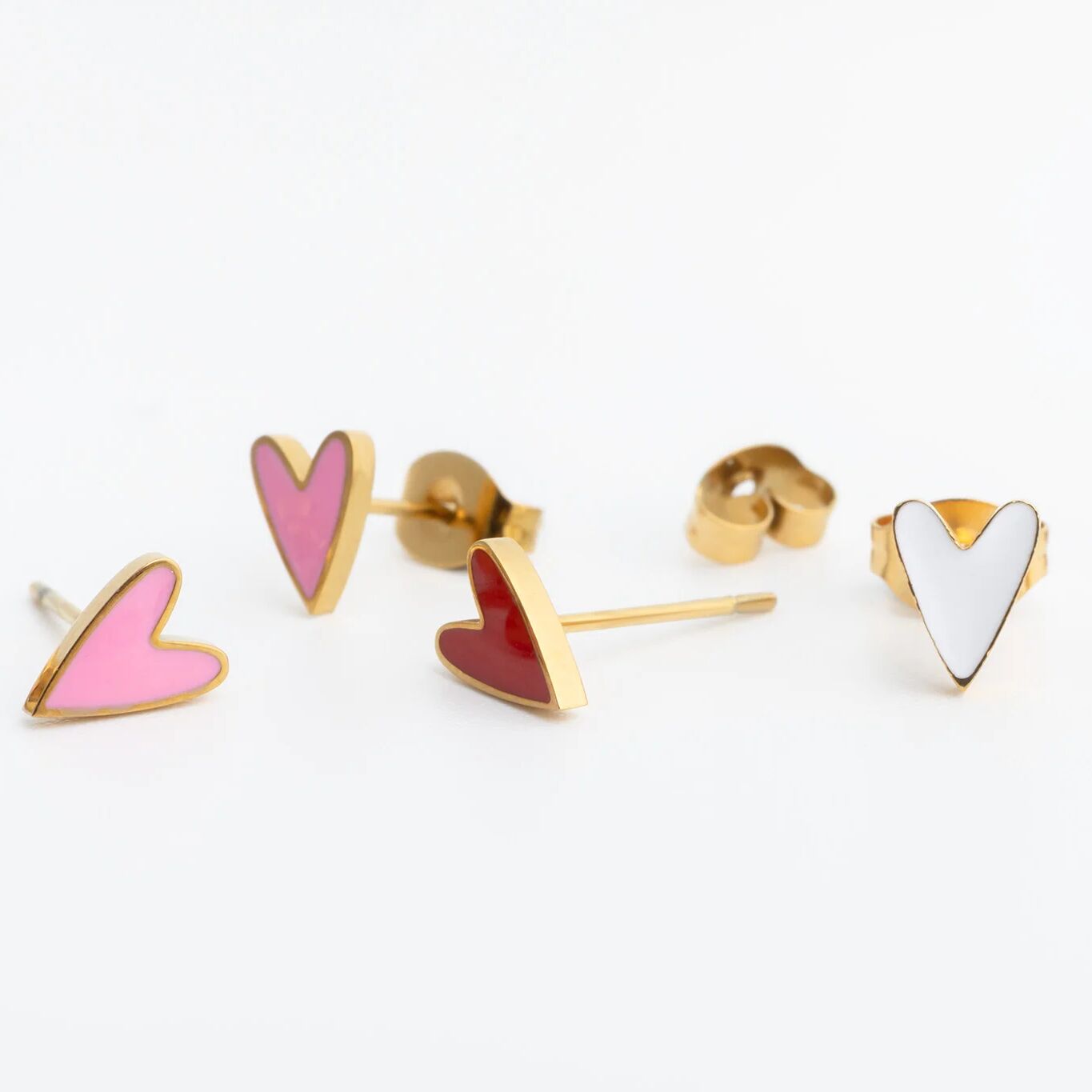 Heart-shaped earrings with gold posts on a white background