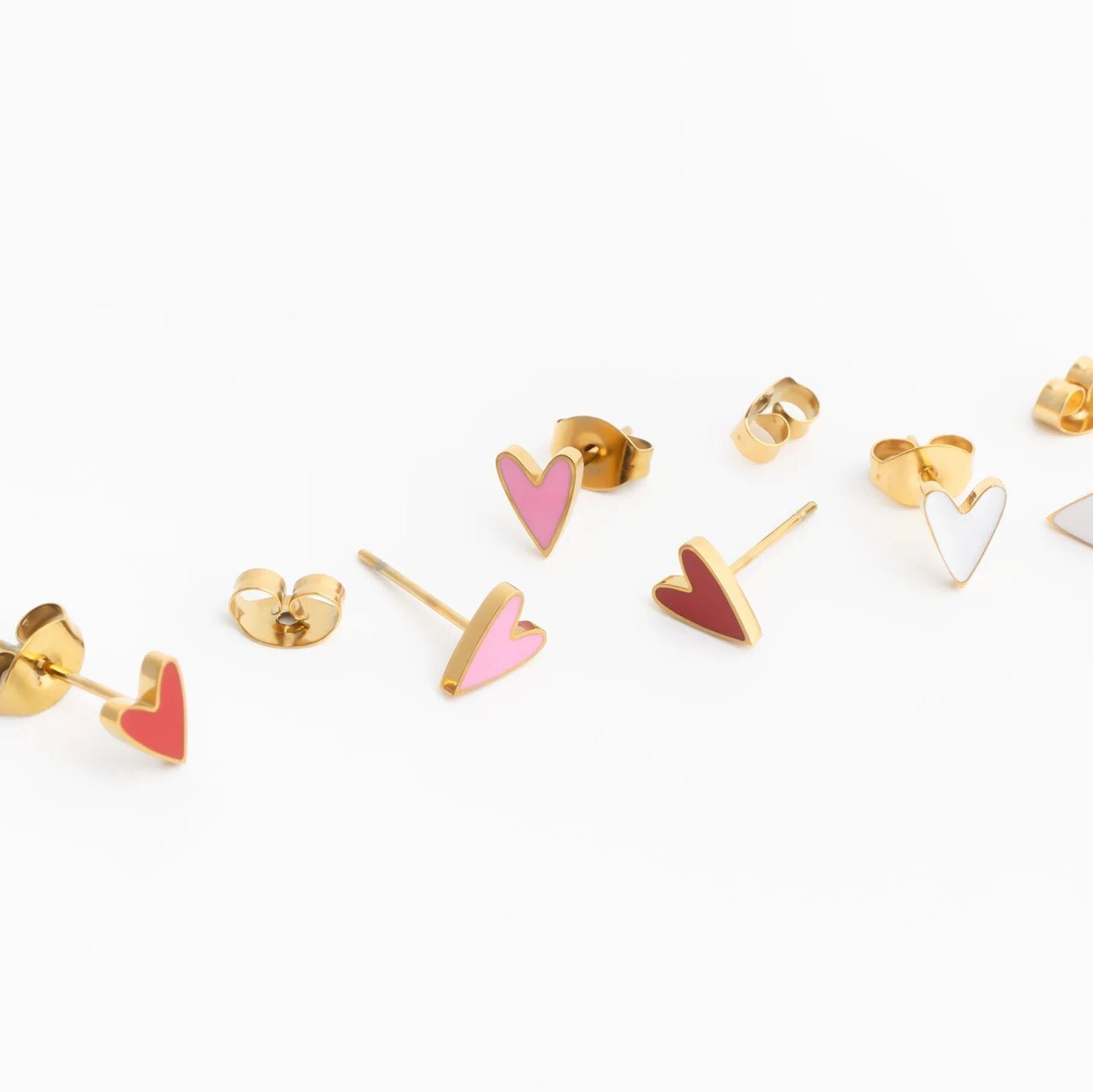 Gold heart-shaped earrings on a white background