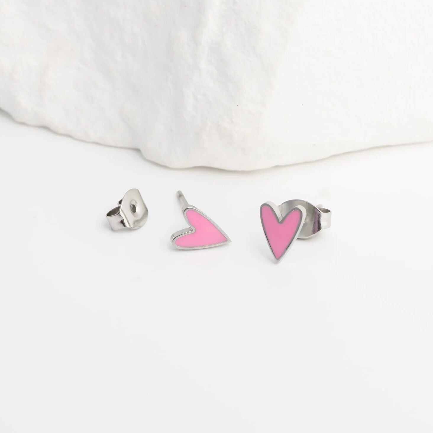 Heart-shaped earrings on a white background
