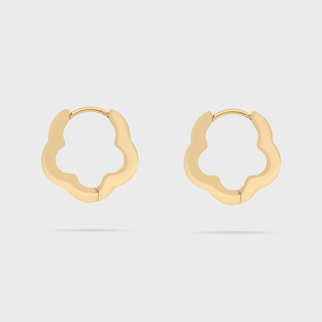 Gold floral hoop earrings on a light gray background