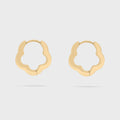 Gold floral hoop earrings on a light gray background