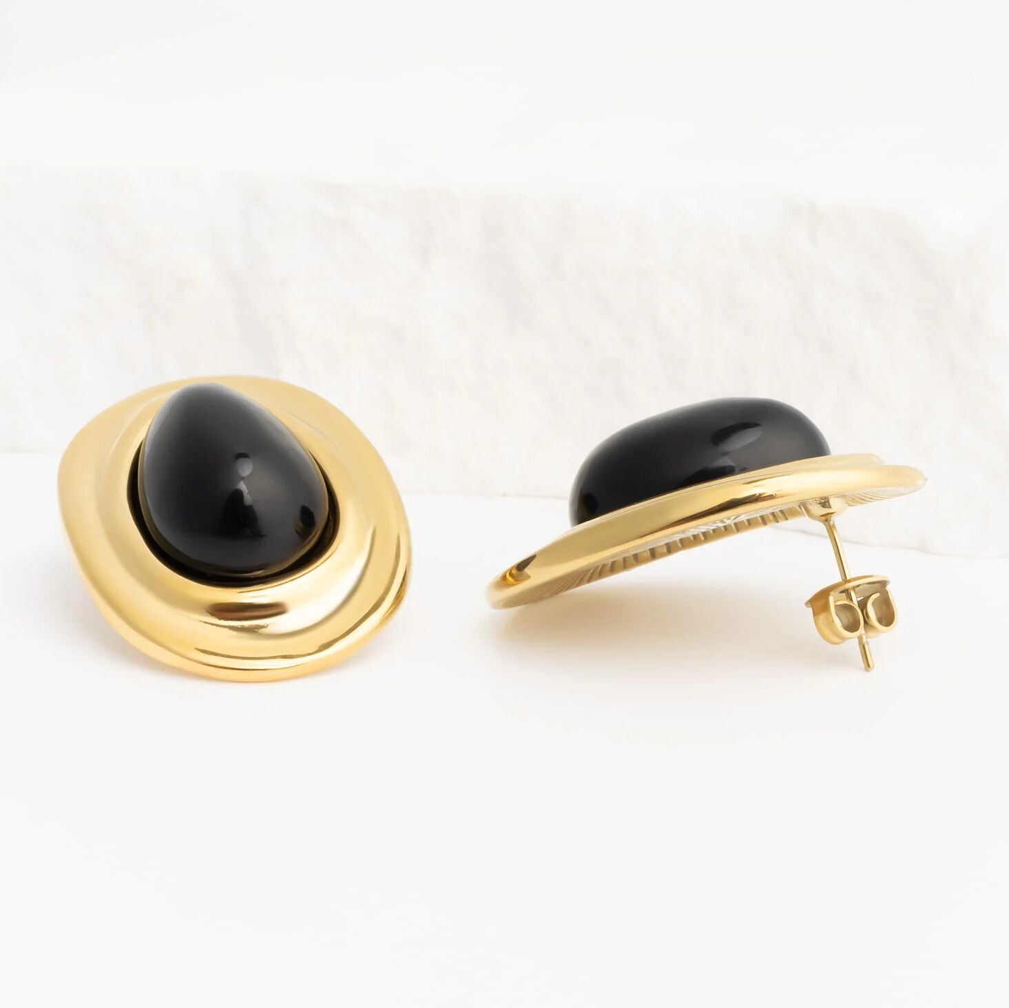 Gold Black Enamel Stud Earrings with black gemstone on a white background