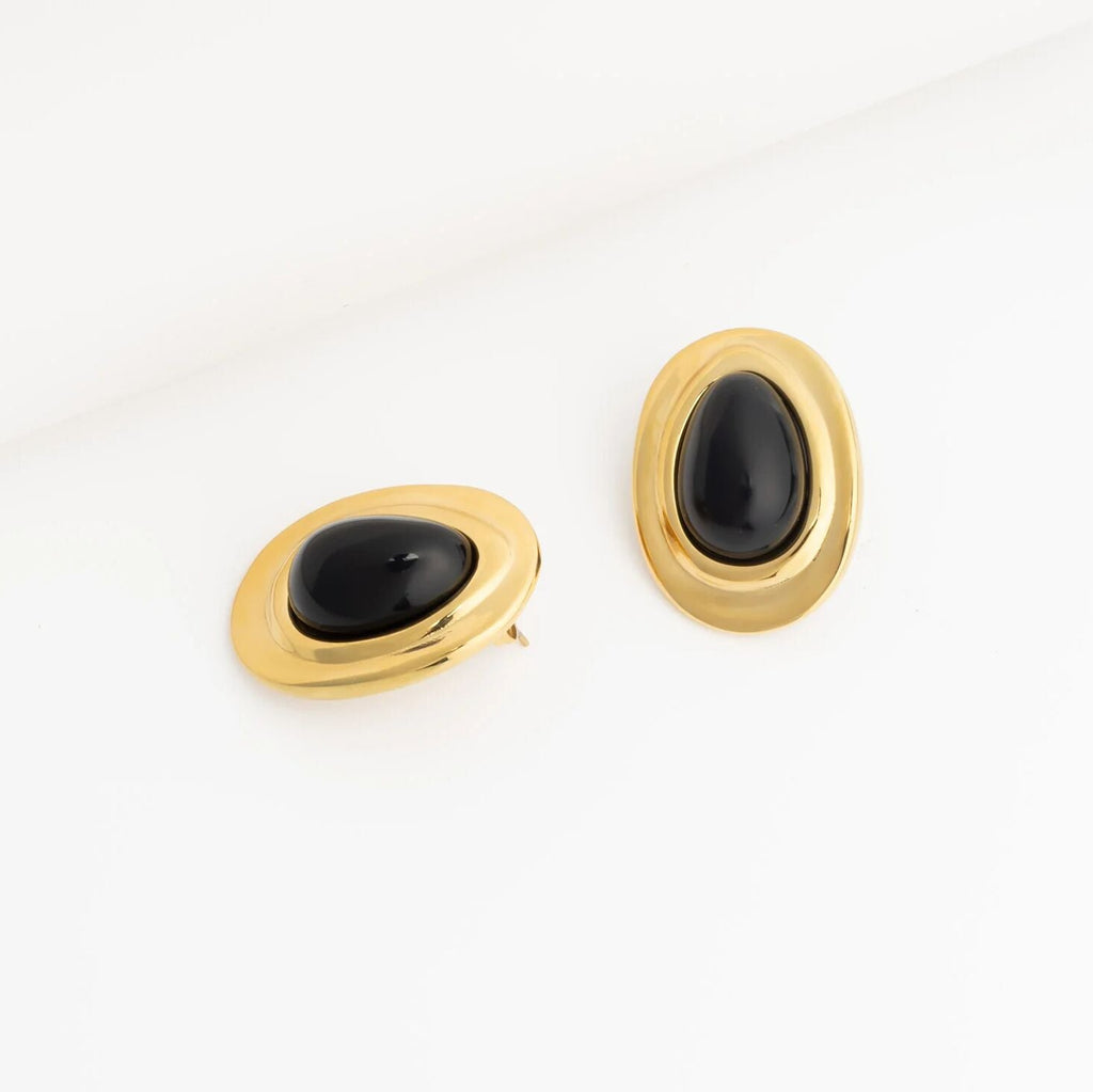 Pair of gold Black Enamel Stud Earrings with black stones on a white background