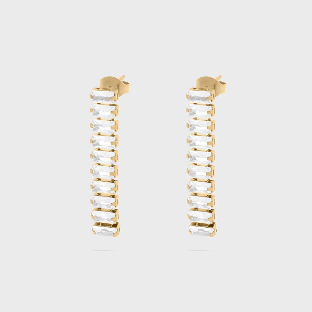 Gold hoop earrings with clear gemstones on a light gray background