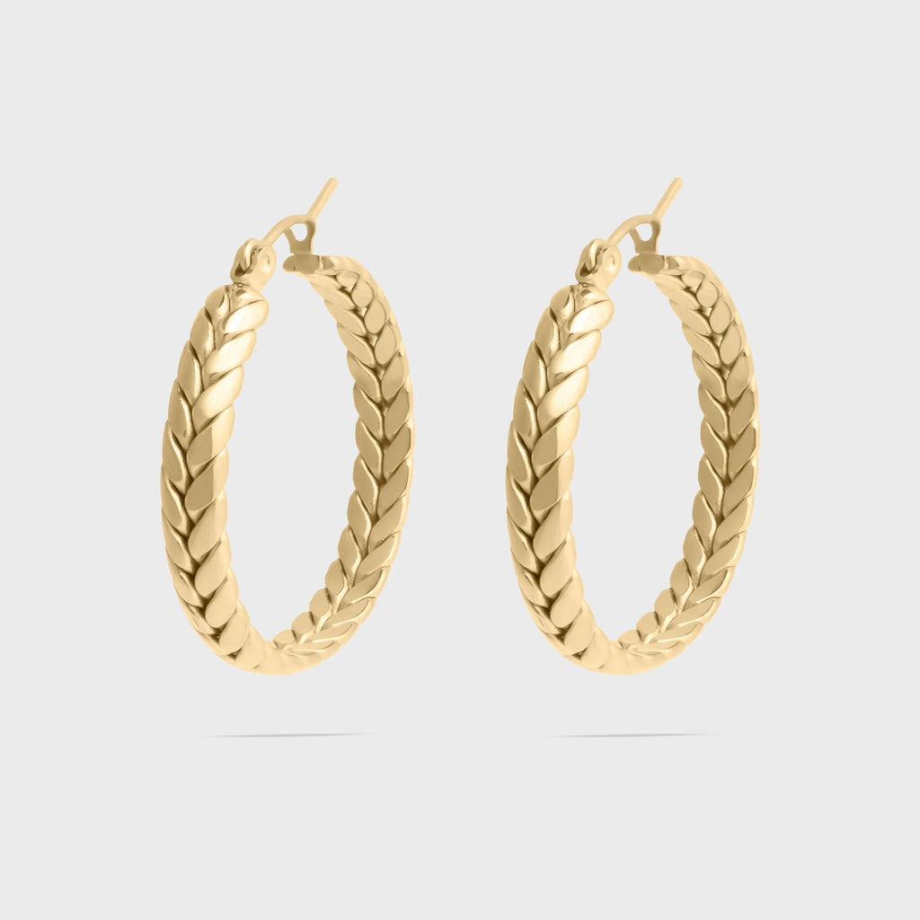 Gold hoop earrings on a light gray background