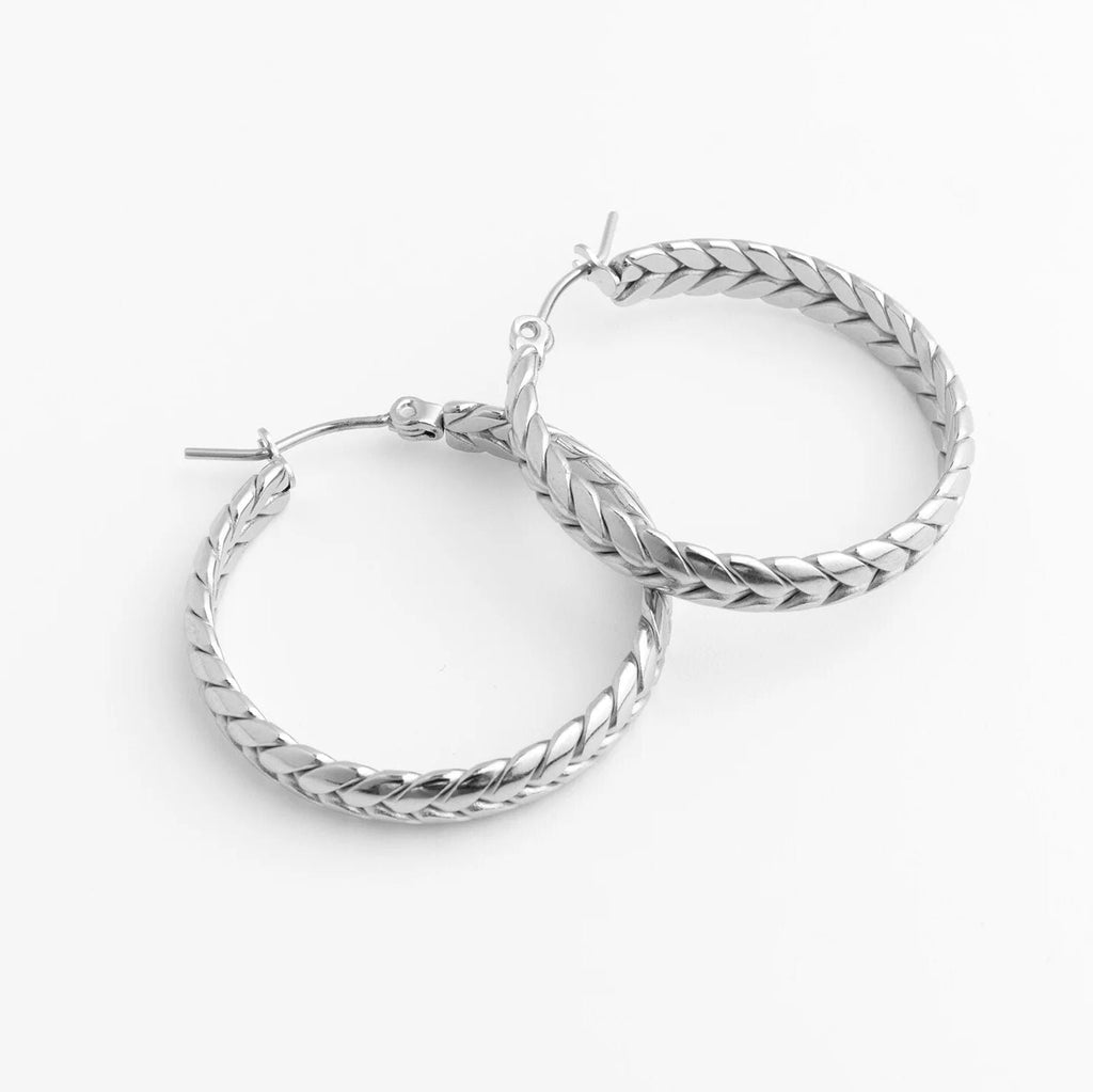 Pair of silver hoop earrings on a white background