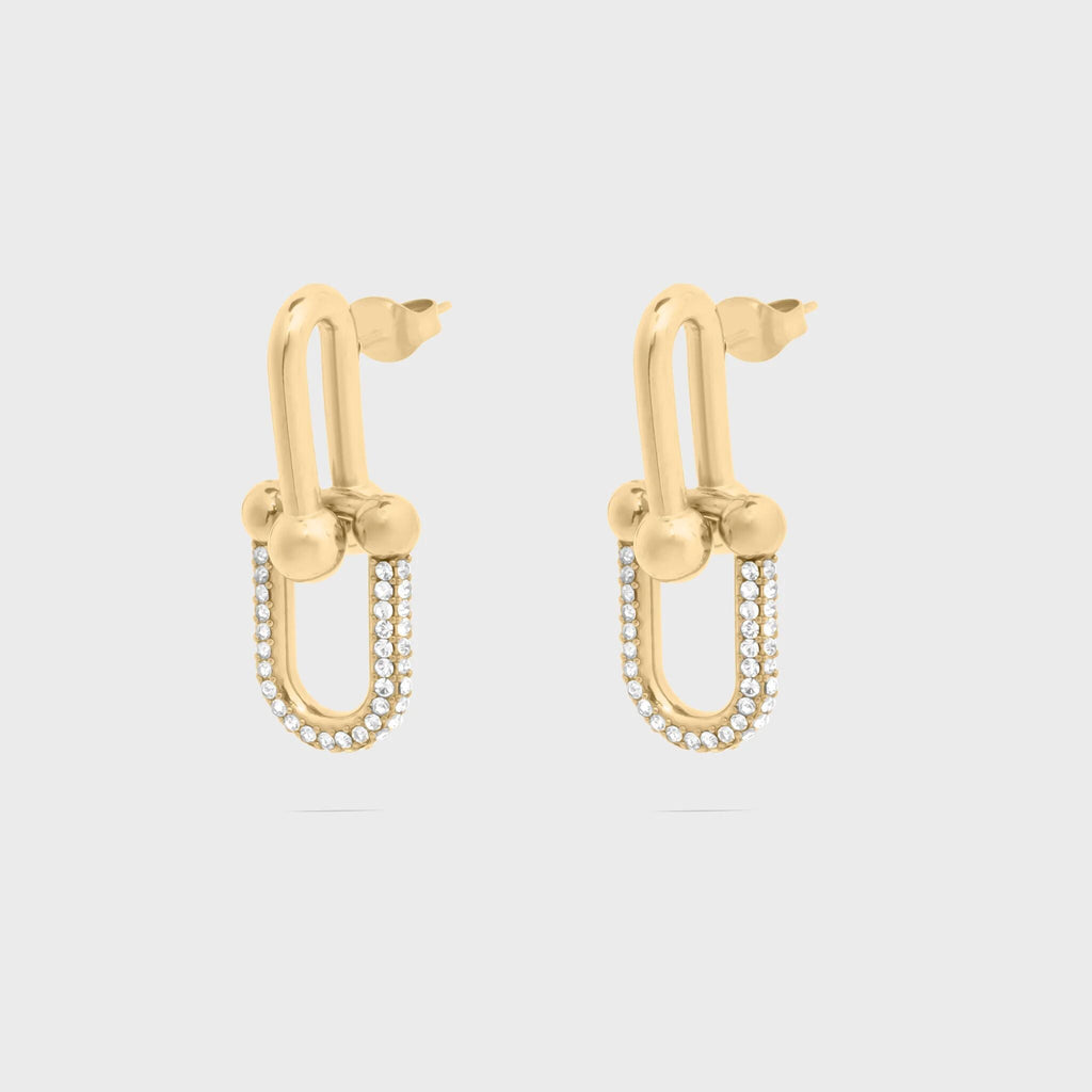 Gold hoop earrings with small beads on a light gray background