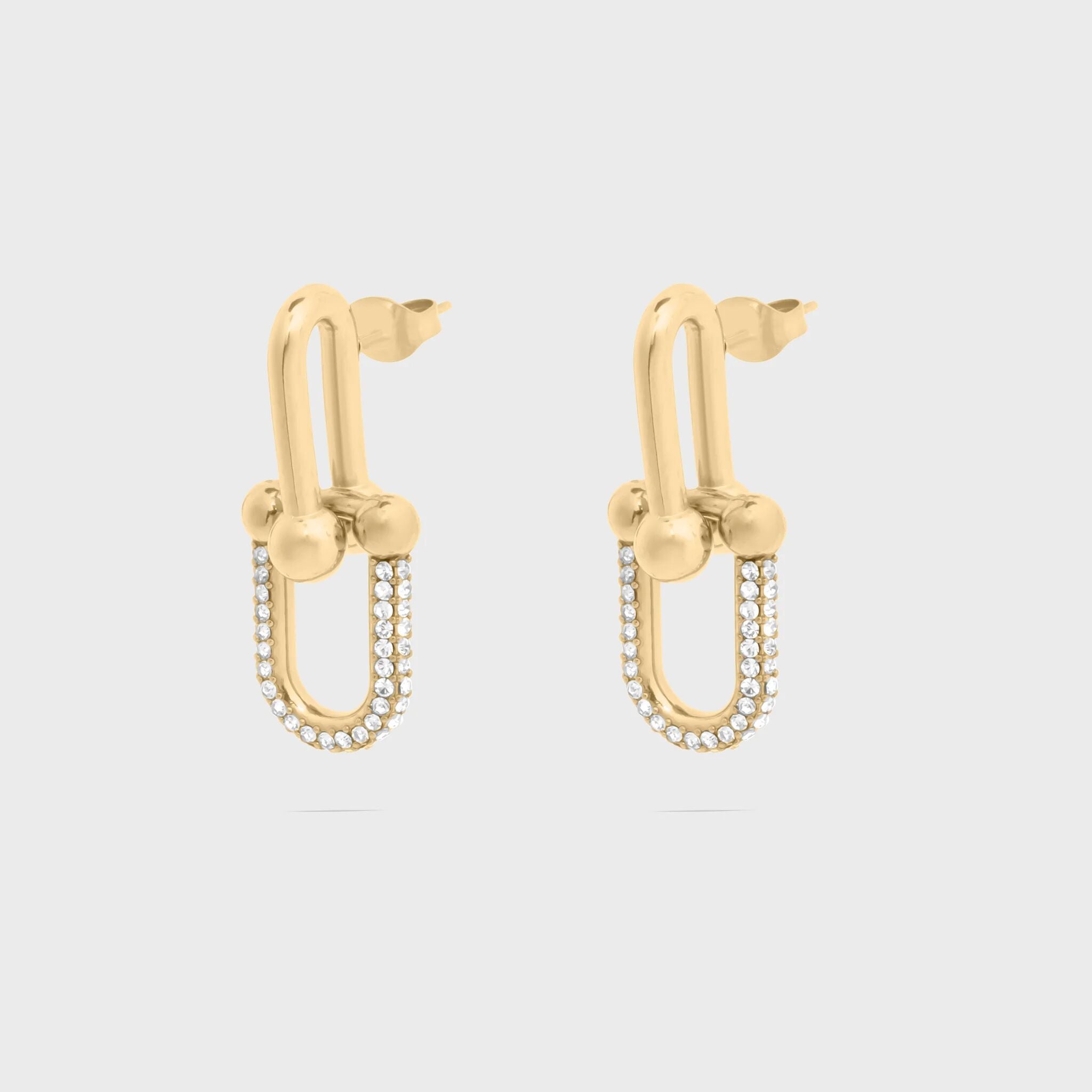 Gold hoop earrings with small beads on a light gray background