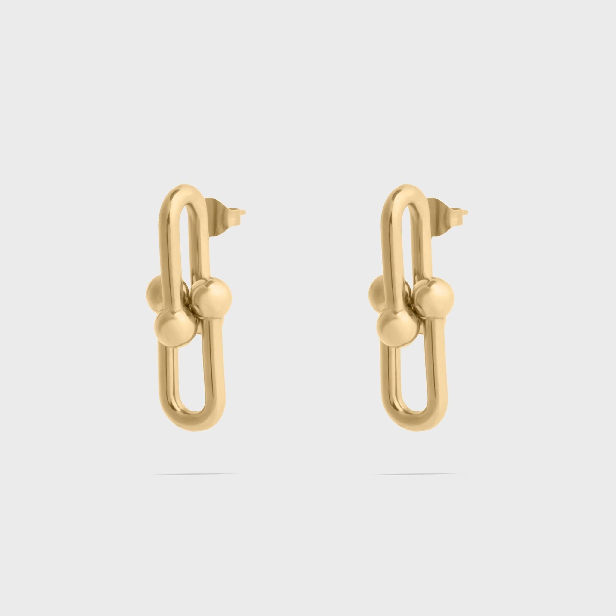 Pair of silver hoop earrings with embedded stones on a white background
