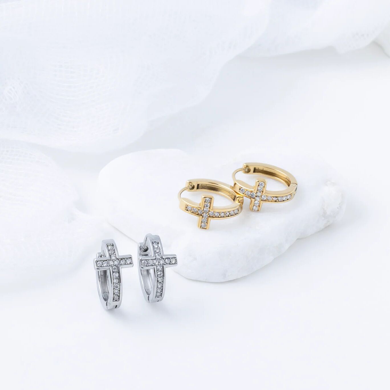 Pair of gold hoop earrings with cz stone accents on a white background
