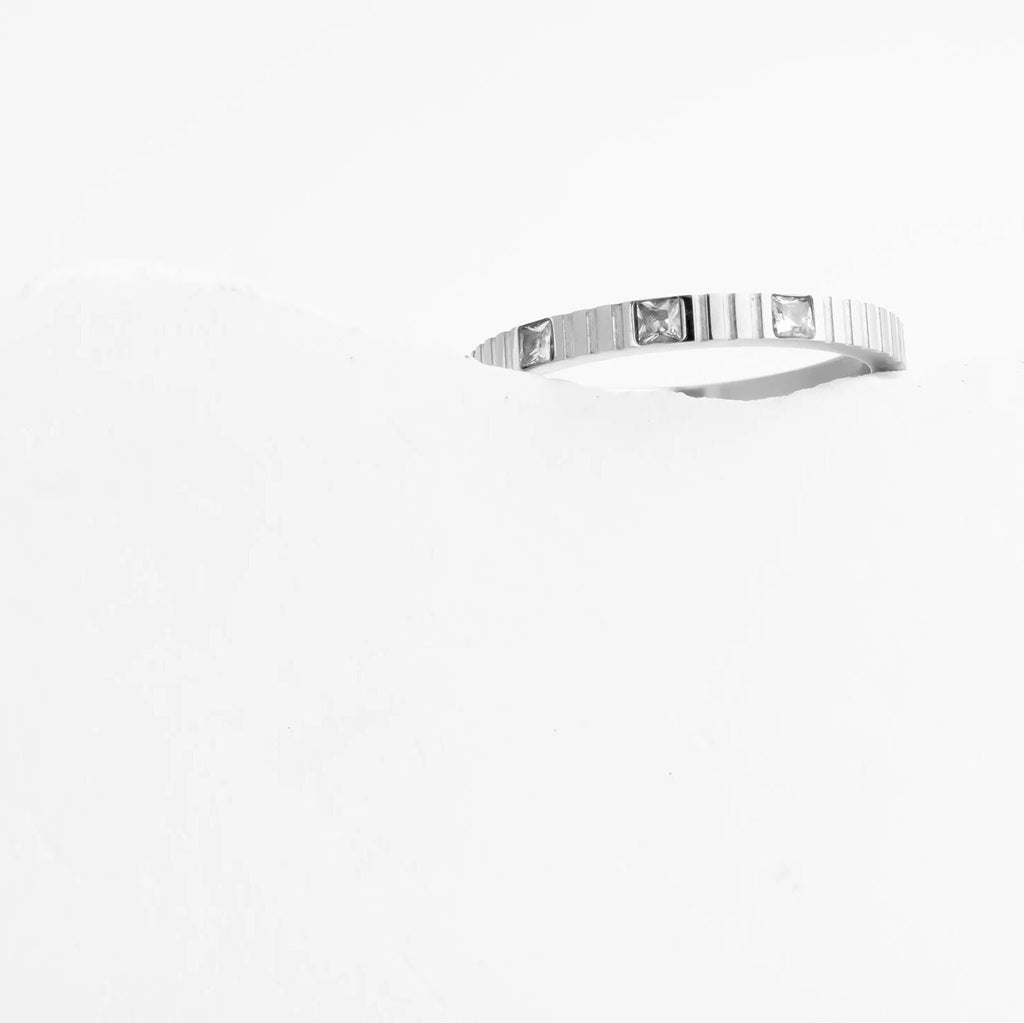 Silver necklace with a rectangular pendant on a white background