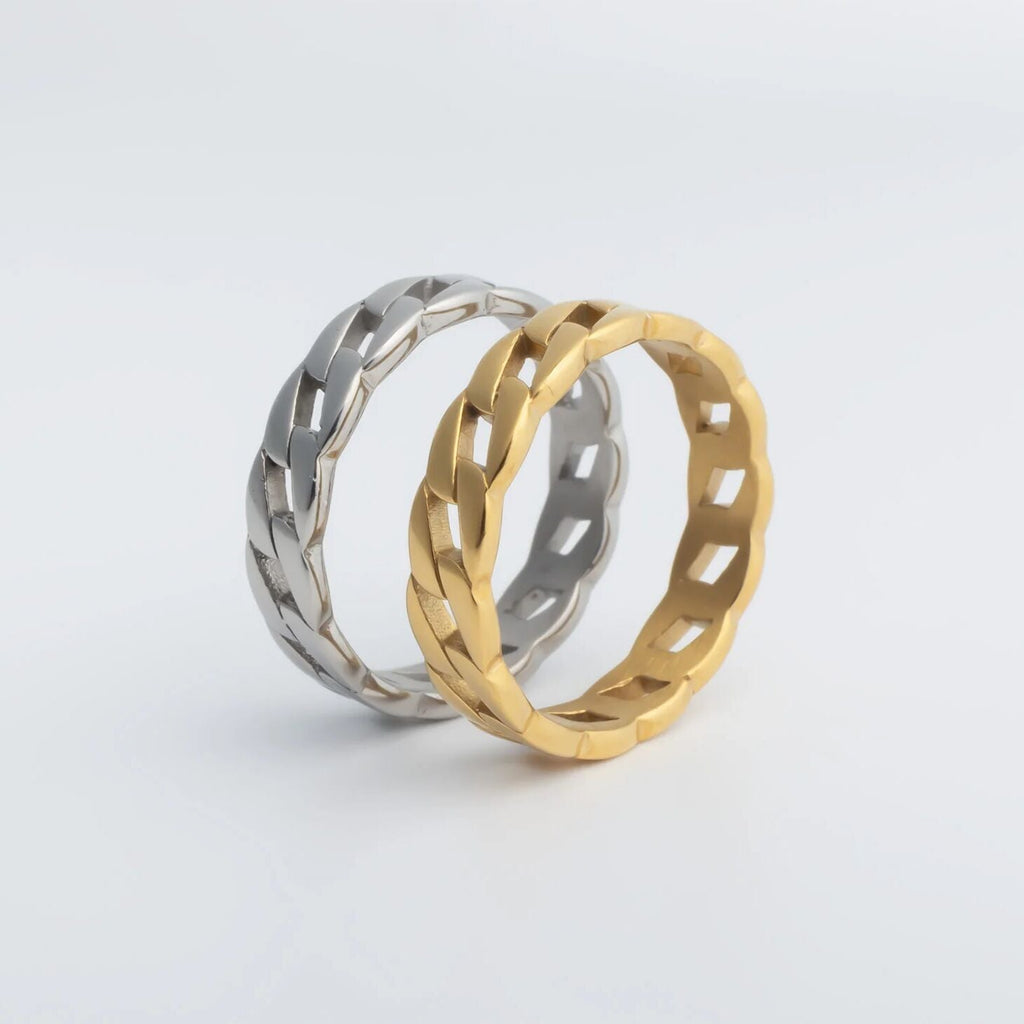 Two gold and silver rings on a light gray background