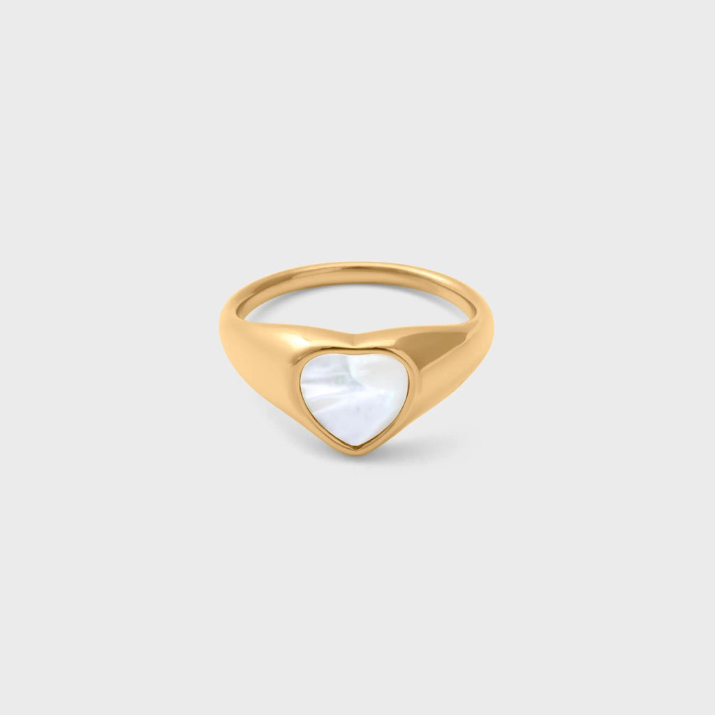 Gold ring with a heart-shaped MOP on a light gray background