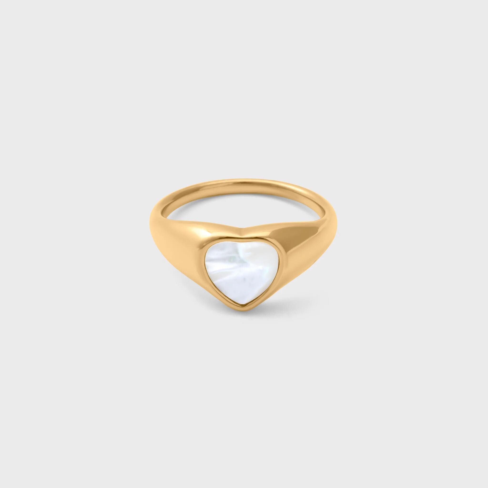 Gold ring with a heart-shaped MOP on a light gray background