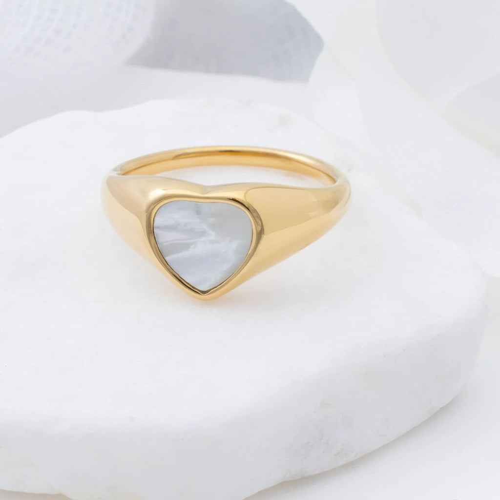 Gold ring with a heart-shaped MOP on a white background