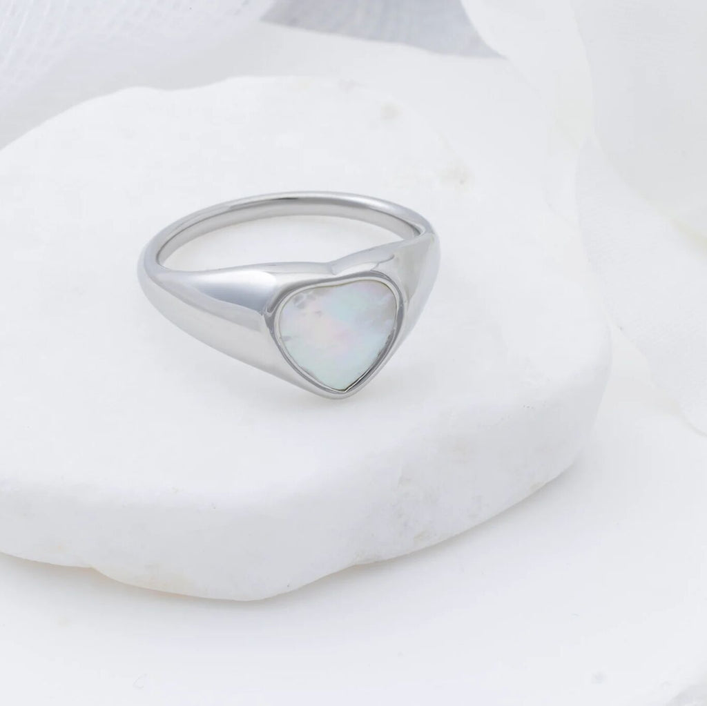 Silver ring with a heart-shaped MOP on a white background